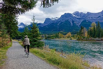 person riding bike on trail