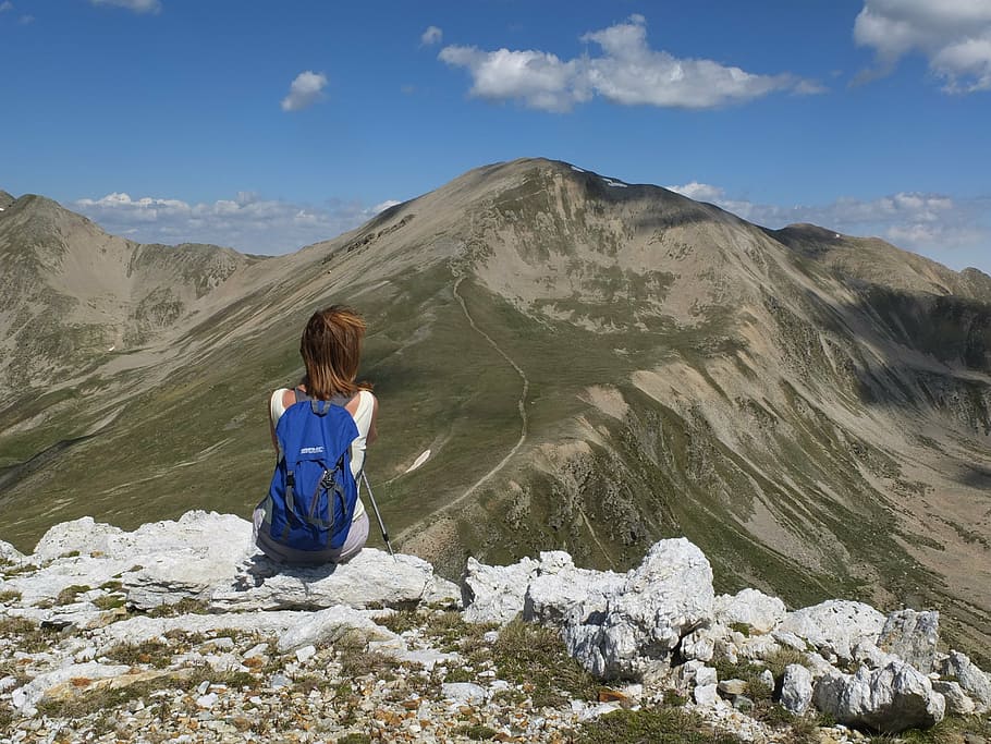 woman sitting on mountain